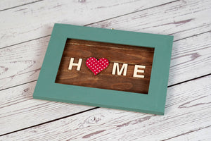 It’s the little things that make a place feel like home, that give it character and style, things like the framed pictures on the shelves or the decorations that adorn the wall